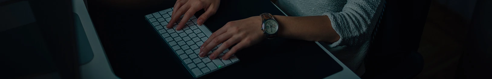 Person typing on the keyboard of a computer